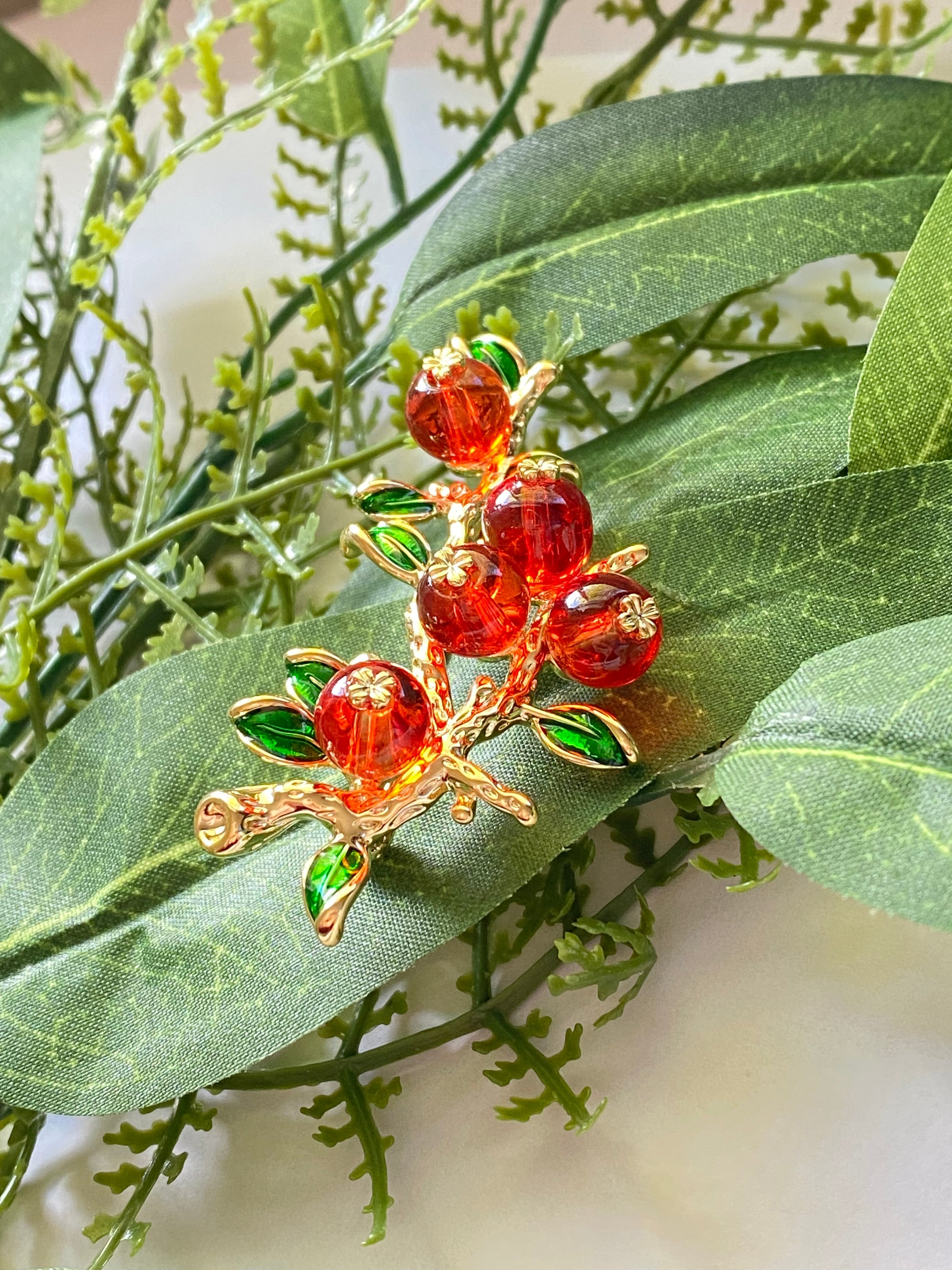 orange and gold brooch pin